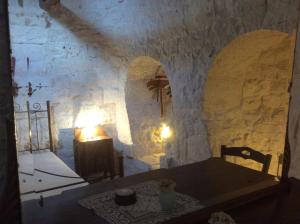 a room with a table and a stone wall at Borgo Miceli in Locorotondo