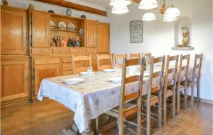 a dining room with a table and wooden cabinets at Amazing Home In Aubignan With 5 Bedrooms, Wifi And Private Swimming Pool in Aubignan