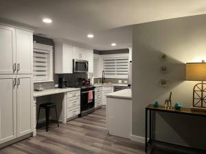 a kitchen with white cabinets and a stove top oven at Travel, Work, Play- alone, family, friends in Mount Prospect