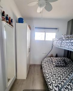a bedroom with a bunk bed and a window at Cabo de Palos apartamento vacacional in Cabo de Palos