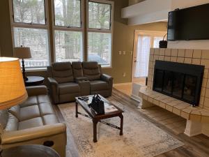 a living room with a couch and a fireplace at Beautiful Lake Harmony Townhouse with views of Big Boulder Lake in Lake Harmony