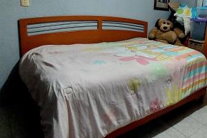 a bed with a white comforter with a teddy bear at Casa Rosa in Tepotzotlán