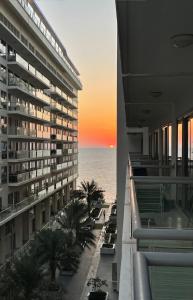 a view of the ocean from the balcony of a building at Infinity Blue - Studio on Al Marjan Island with a private beach in Ras al Khaimah