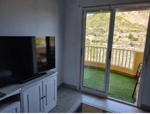 a kitchen with a large sliding glass door with a balcony at Cabo de Palos apartamento vacacional in Cabo de Palos