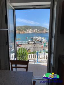 a view of a marina from a large window at Magi - Pergola in Ponza +8 photos