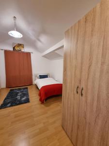 a bedroom with a bed and a large wooden door at Workers Home Salzburg in Salzburg +8 photos