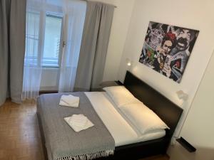 a bedroom with a bed and a window with a poster at Carillon by BestChoice - Old City - Self Check-in with PARKING option in Graz