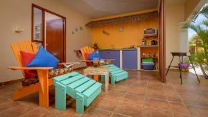 a living room with colorful chairs and a table at Djambo in Kralendijk