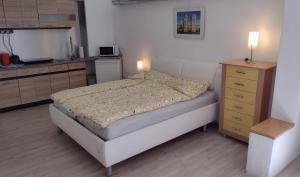 - une petite chambre avec un lit et une commode dans l'établissement Kleines gemütliches Apartment in zentraler Lage, à Prien am Chiemsee