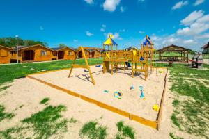 a playground in the sand in a park at VIKING Gąski in Gąski