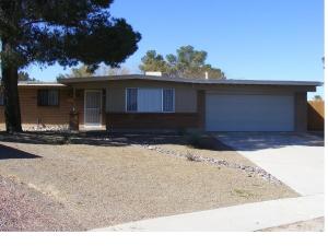 a house with a tree and a driveway at Casa de Basswood in Tucson