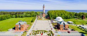 an aerial view of a building with a lighthouse at Domki Letniskowe Blue Sky 1 in Rewal +13 photos