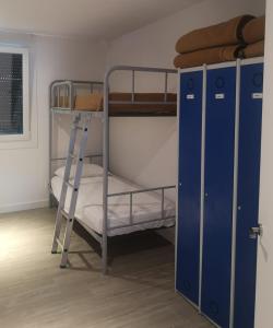 a bunk bed room with two bunk beds and a ladder at Erletxe Aterpea in Lezo