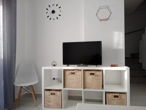 a white cabinet with a tv on top of it at Siorica Beach in Matalascañas