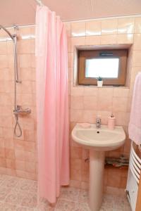 a bathroom with a pink shower curtain and a sink at Discovery Apartment Bansko in Bansko +10 photos