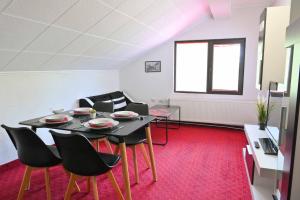 a living room with a table and chairs at Discovery Apartment Bansko in Bansko