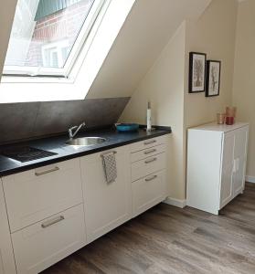 a kitchen with a sink and a window at Ferienwohnung Adriane in Nordhorn