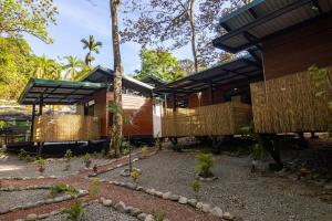 a house in the middle of a garden with trees at Riverside Villas in Manuel Antonio