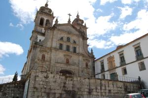 an old building with a clock tower next to a building at Convento de Tibaes in Braga