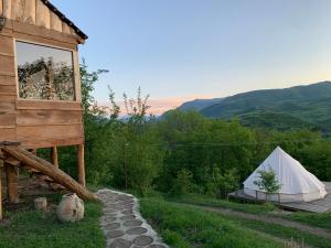 a tent and a teepee with a view of the mountains at Alereks Mountain Camping in Dsegh
