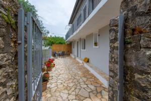 a stone courtyard of a house with a stone wall at Porto Gaios House in Gaios