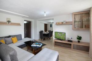 a living room with a couch and a tv at Porto Gaios House in Gaios