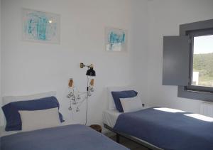 a hospital room with two beds and a window at Agapito's Houses in Praia de Odeceixe