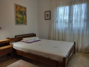 a bedroom with a bed and a window at Serapis Country House on the hill above Heraklion Off grid in Archanes