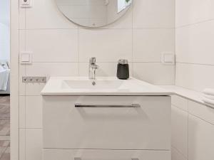 a white bathroom with a sink and a mirror at Holiday home HÖLLVIKEN III in Höllviken