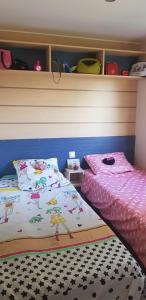 a bedroom with two beds and a headboard at Splendide mobil-home in Narbonne