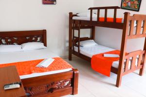 a bedroom with two bunk beds and a desk at Casa del Mar in Tolú