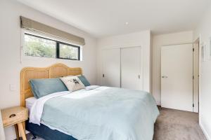 a bedroom with a large bed and a window at River Range Cottage - Havelock North Holiday Home in Havelock North