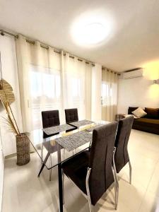 a dining room with a glass table and chairs at Royal in Salou +13 photos