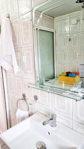 a bathroom with a sink and a mirror at Liora's Place in Korçë