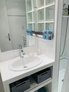 a white bathroom with a sink and a mirror at Butterfly-Palais des Festival-center-quiet-AC-Wi Fi parking in Cannes