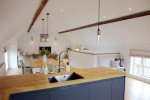 a kitchen with a sink and a counter top at The Barn @Bourne Eau House in Bourne +7 photos