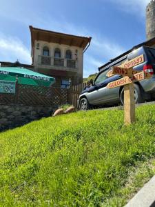 a sign in the grass in front of a house at Golden Gate in Akhaltsikhe