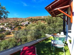 a patio with a table and chairs on a balcony at FAMILY COTTAGE AMONG OLIVE TREES in Agüimes