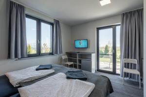 Telewizja i/lub zestaw kina domowego w obiekcie PIONOW Pokoje Hotelowe - adults only