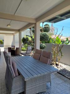 una mesa de madera y sillas en un patio en Casa d' Avó Zeza, en Jardim do Mar