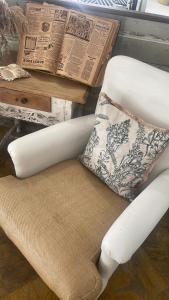 a white chair with a pillow next to a table at Labreña Hotel in Los Caños de Meca