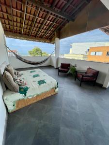 a bedroom with a hammock on a balcony at Hope Hostel Guarapari in Guarapari