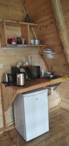 a kitchen in a wooden cabin with a counter top at Bazaletis Akvani 