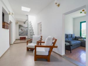 a living room with a couch and chairs at FAMILY COTTAGE AMONG OLIVE TREES in Agüimes