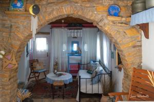 a living room with a stone archway and a table at Leros Windmills in Panteli