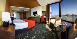 a hotel room with a bed and a large window at Boutique Hotel Victoria Budapest in Budapest +37 photos