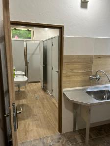 a bathroom with a sink and two toilets at Chatový areál ATLAS in Staňkov