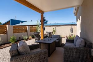 a patio with wicker chairs and a table at Crescent Moon Casita, 2 Bedrooms, Patio, WiFi, Sleeps 4 in Santa Fe
