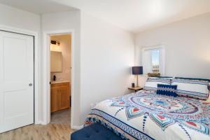 a white bedroom with a bed and a bathroom at Crescent Moon Casita, 2 Bedrooms, Patio, WiFi, Sleeps 4 in Santa Fe