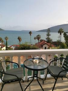 a table and chairs on a balcony with a view of the ocean at Petrovic house in Herceg-Novi